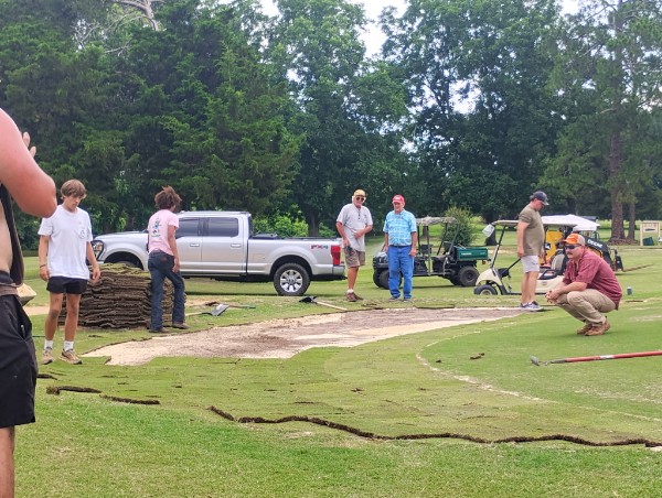 working on the greens at Brundidge Country Club